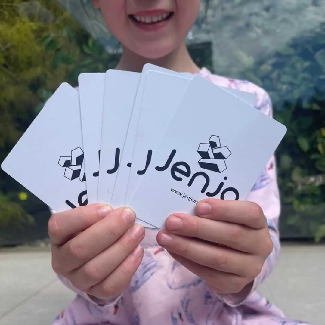 a girl holding playing cards