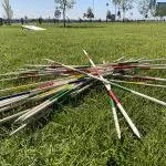 a group of wooden sticks on grass