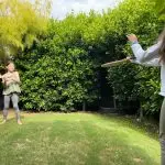 Girls Hitting A Black Ball In The Backyard