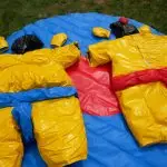 Kids Sumo Suits a yellow and black sumo suit on blue and red mat