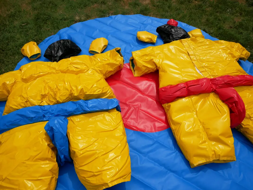 Kids Sumo Suits a yellow and black sumo suit on blue and red mat